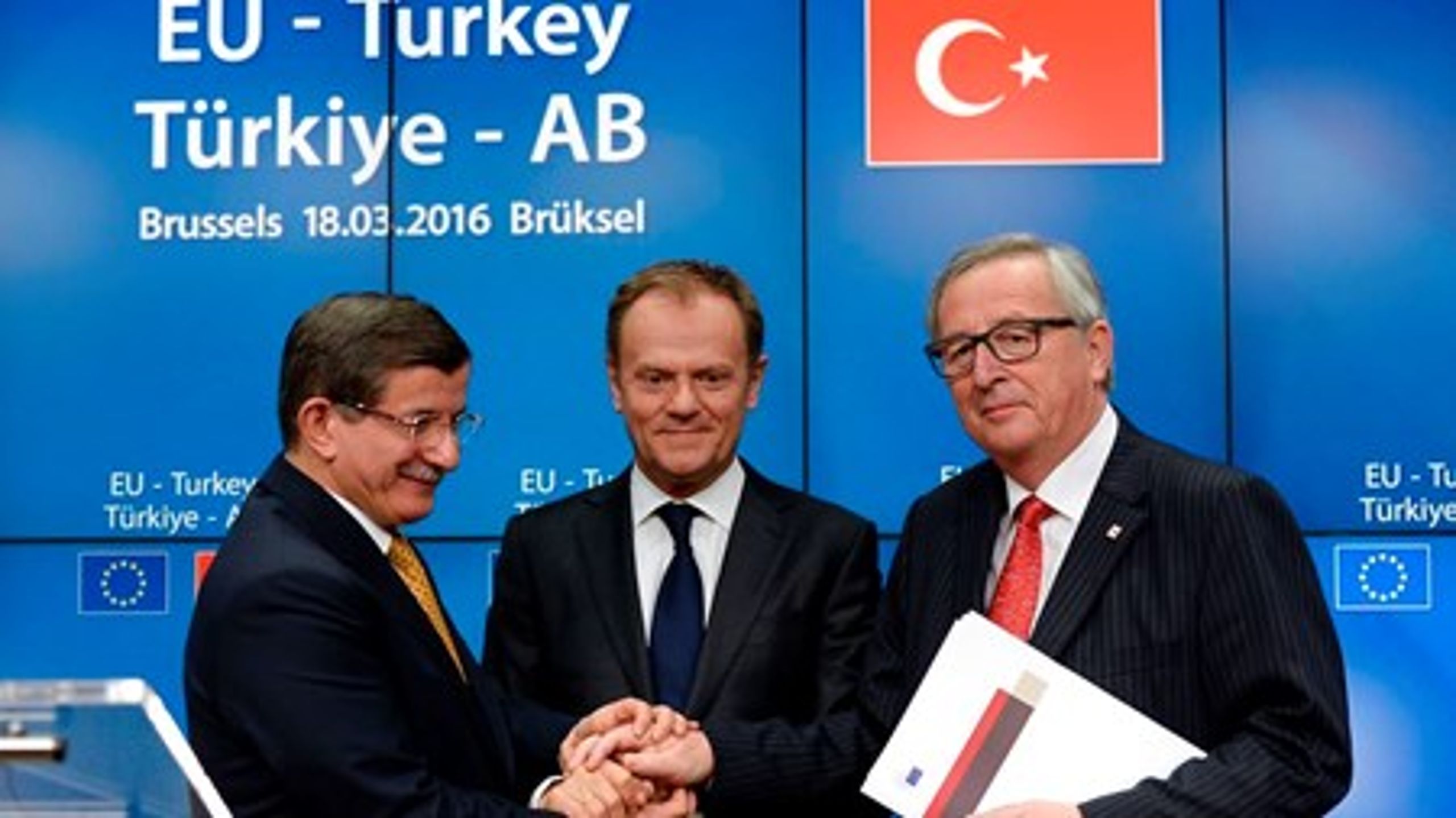 Den tyrkiske premierminister, Ahmet Davutoglu, trykker hænder med formændene for Det Europæiske Råd og EU-Kommissionen, Donald Tusk og Jean-Claude Juncker.